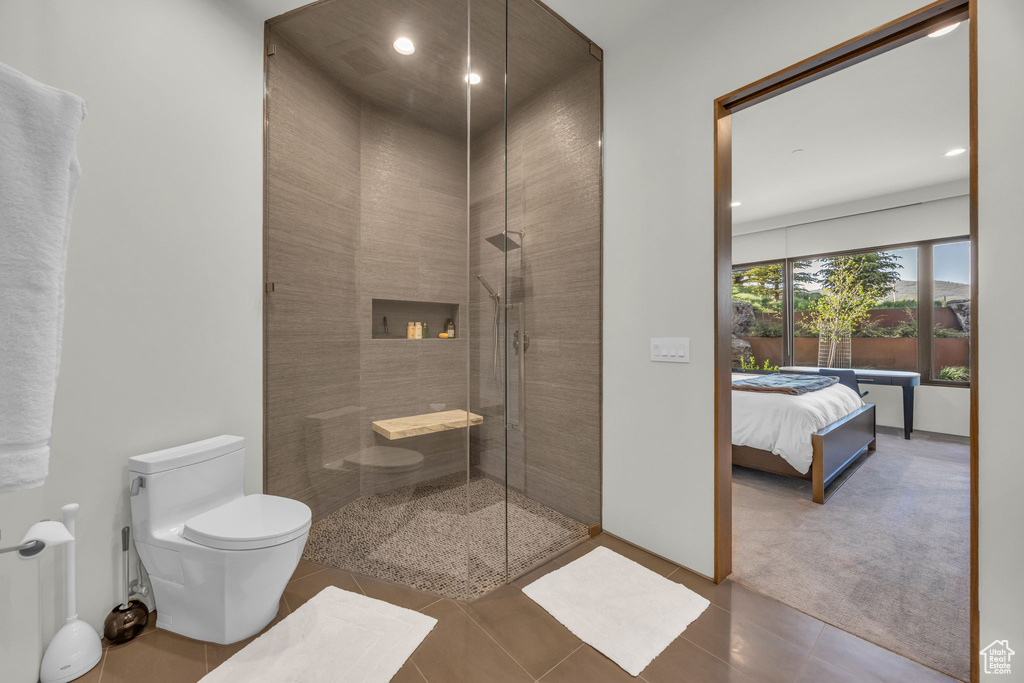 Full bathroom with toilet, tile patterned floors, tiled shower, recessed lighting, and ensuite bath