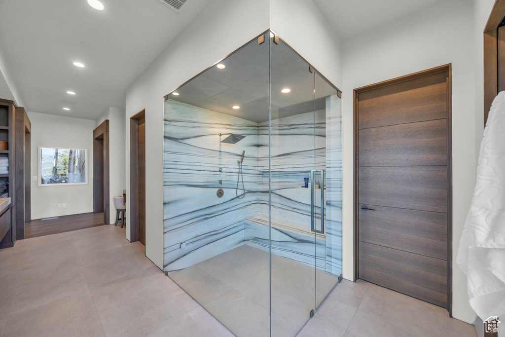 Bathroom featuring recessed lighting and a marble finish shower