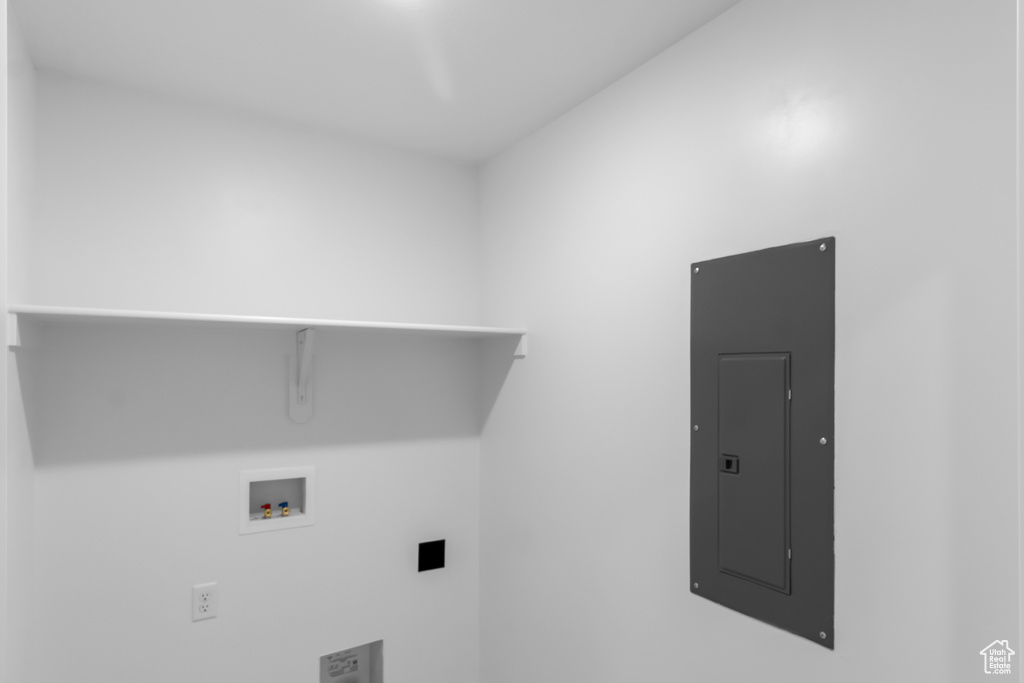 Laundry area with electric panel and hookup for a washing machine