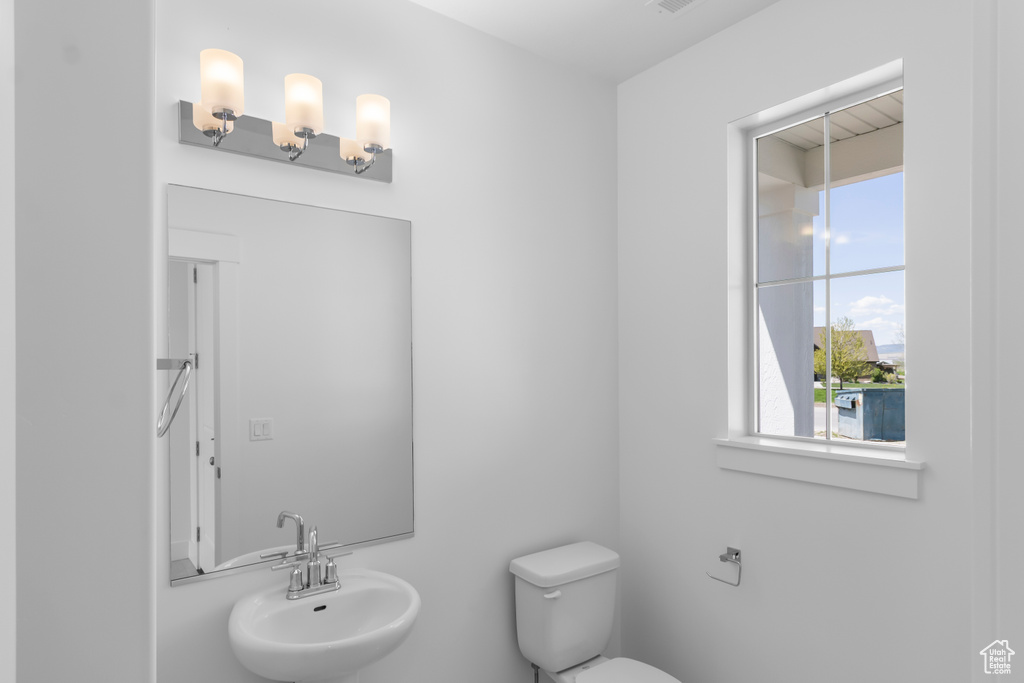 Half bath featuring a sink and toilet