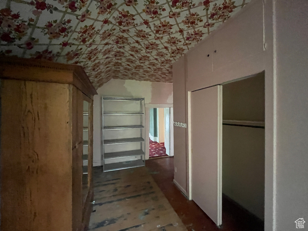 Additional living space featuring wood finished floors and vaulted ceiling