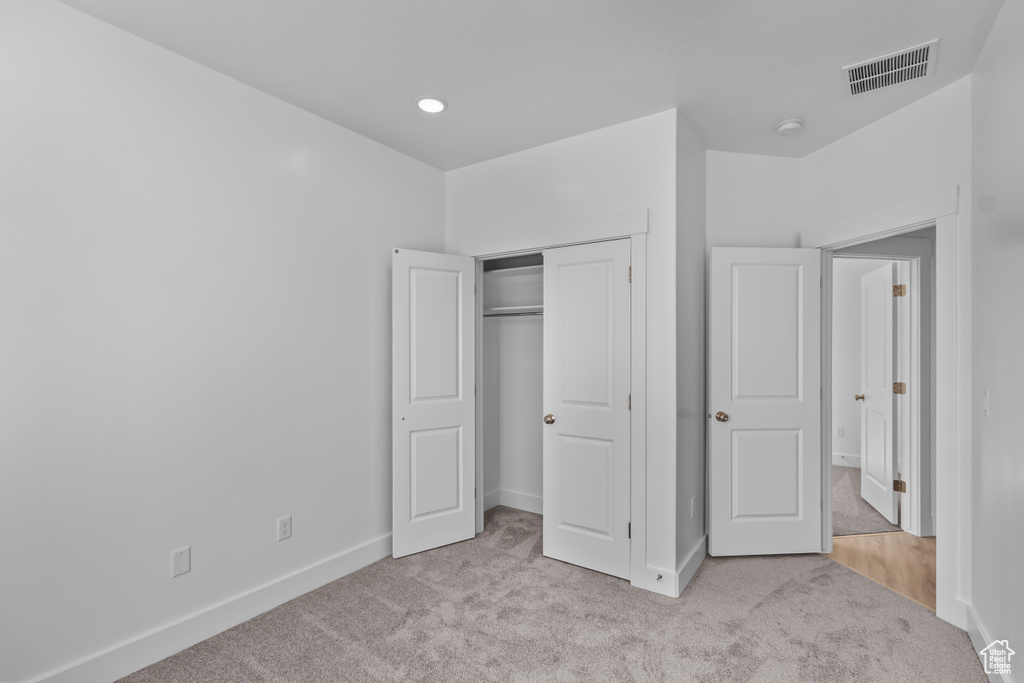 Unfurnished bedroom with carpet flooring, baseboards, and a closet