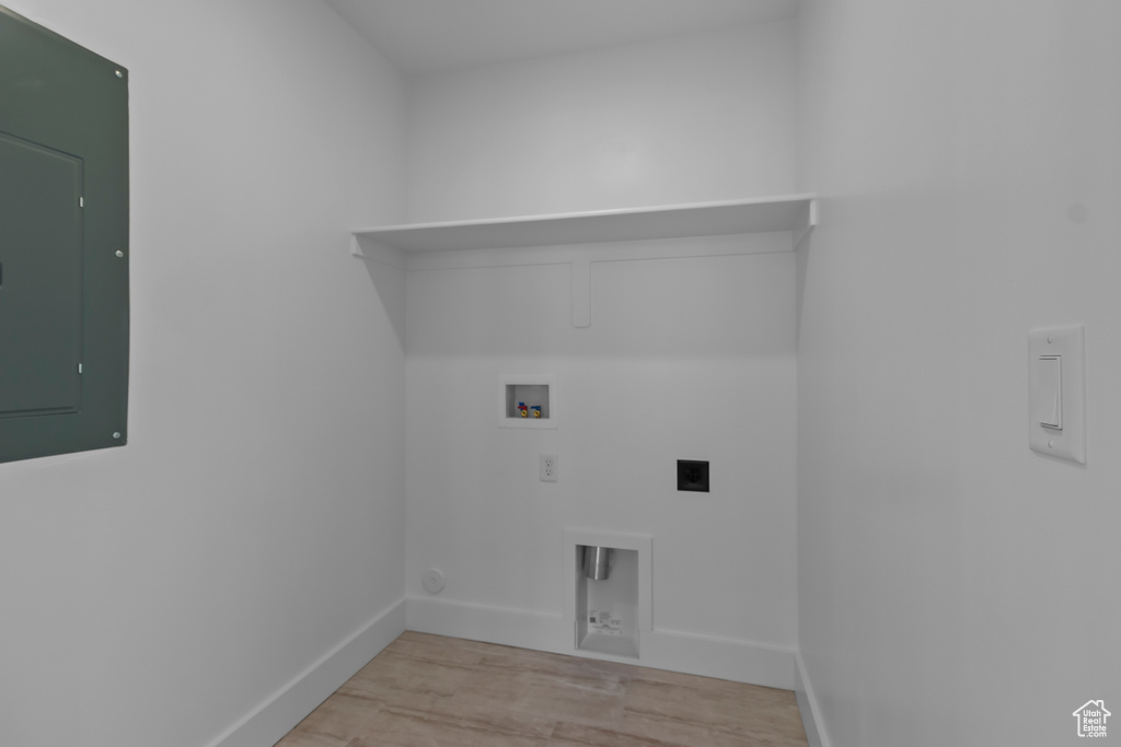 Laundry area featuring electric panel, hookup for an electric dryer, baseboards, washer hookup, and light wood-style flooring