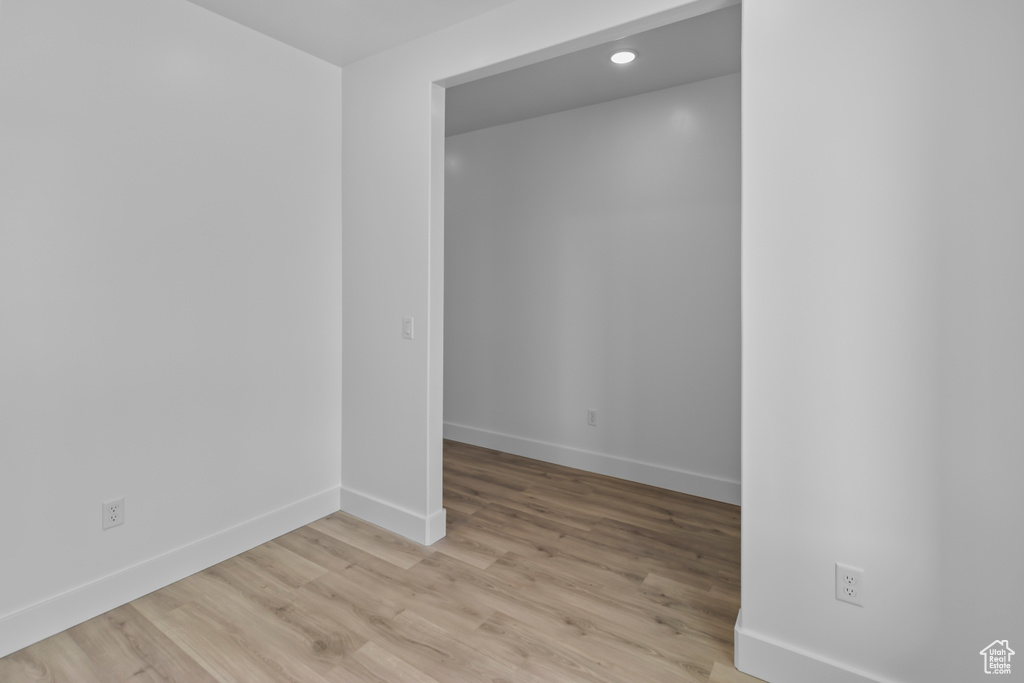 Spare room with baseboards, light wood finished floors, and recessed lighting