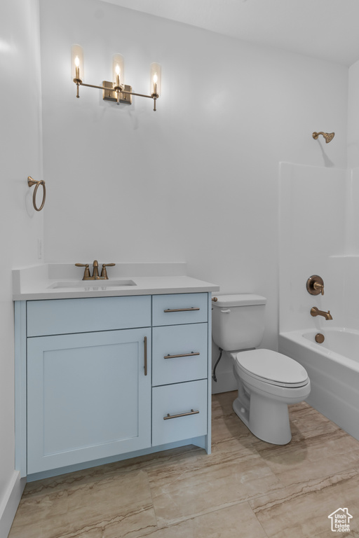 Full bathroom with vanity, toilet, shower / bath combination, baseboards, and a chandelier