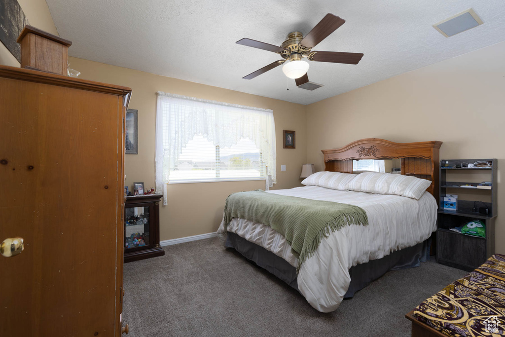 Bedroom featuring carpet flooring, baseboards, and ceiling fan