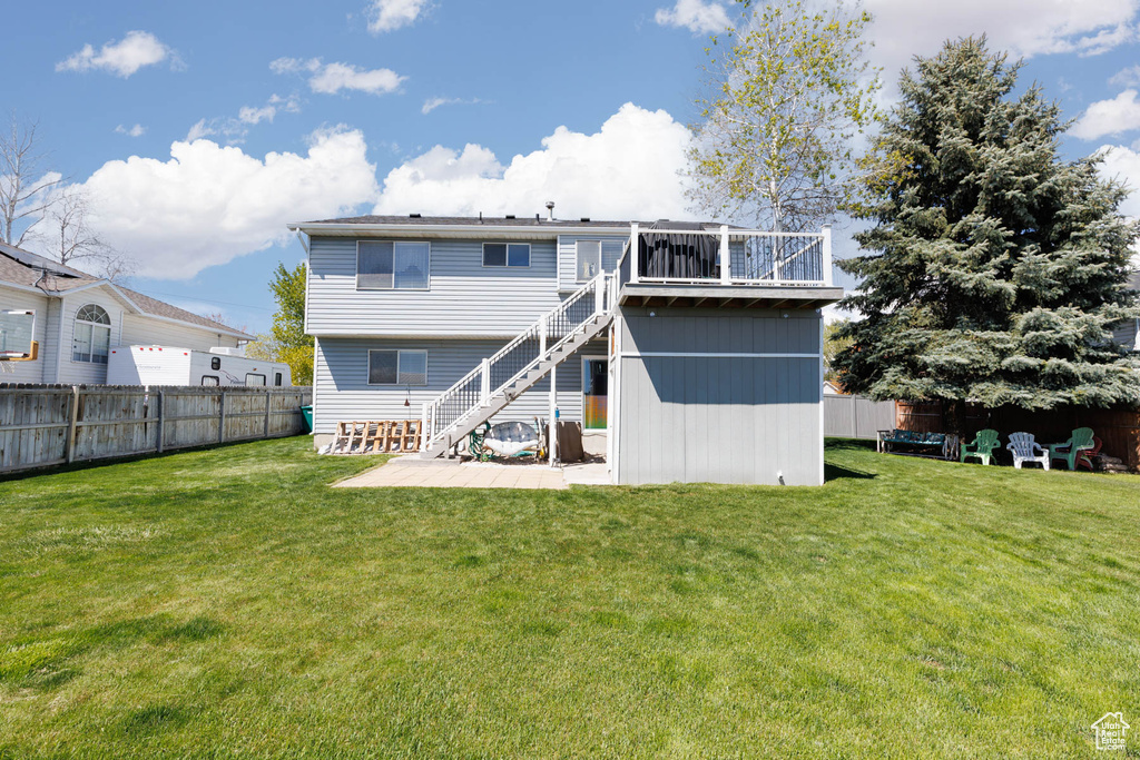 Rear view of property featuring stairs and a deck