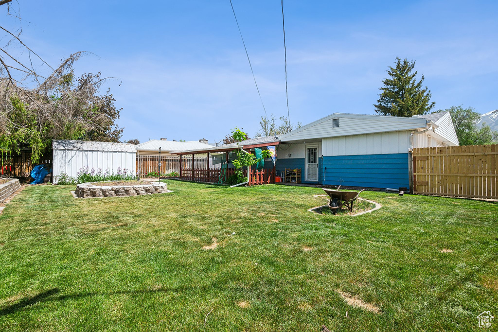 View of yard featuring an outbuilding and a storage shed