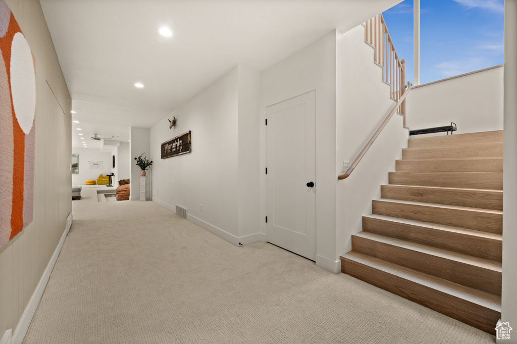 Corridor featuring stairs, recessed lighting, carpet floors, and baseboards