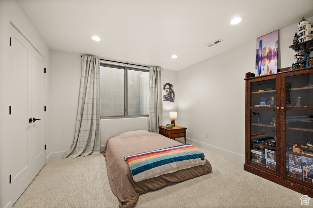 Carpeted bedroom with recessed lighting and baseboards