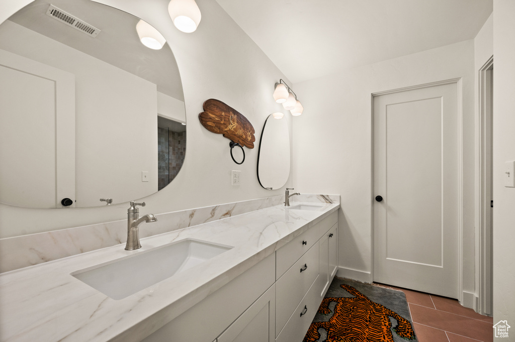 Full bathroom with double vanity and tile patterned flooring