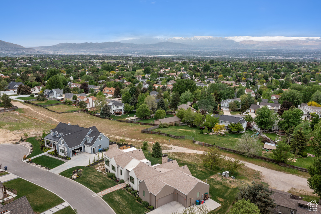 Aerial perspective of suburban area featuring a mountainous background