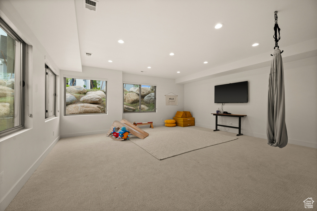 Playroom featuring light colored carpet, baseboards, and recessed lighting