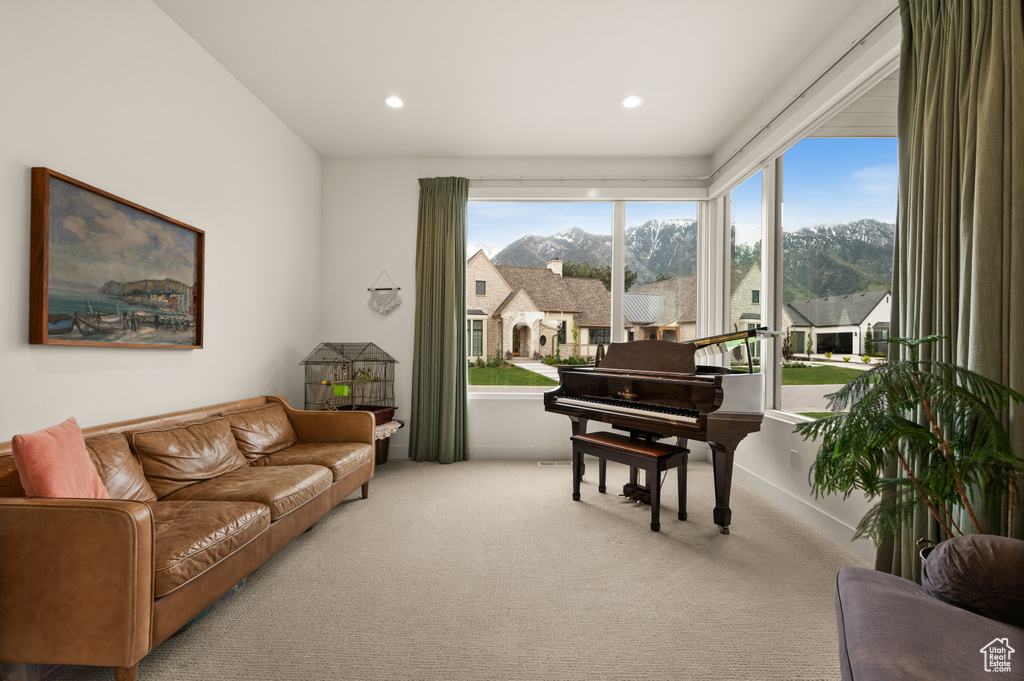 Living area with carpet, a mountain view, and recessed lighting