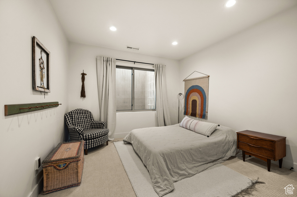 Bedroom featuring light carpet, recessed lighting, and baseboards