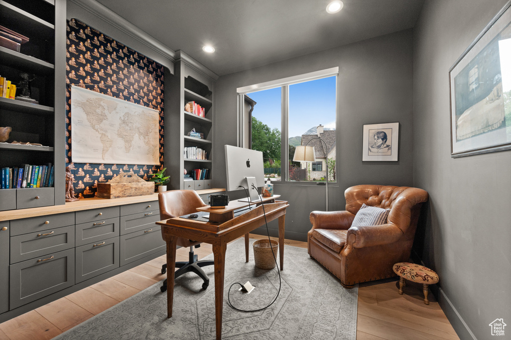 Office space with light wood-type flooring, built in features, recessed lighting, and baseboards