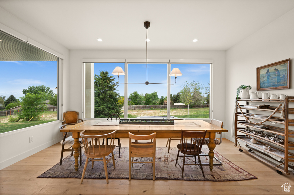 Dining room featuring baseboards, light wood-style floors, and recessed lighting