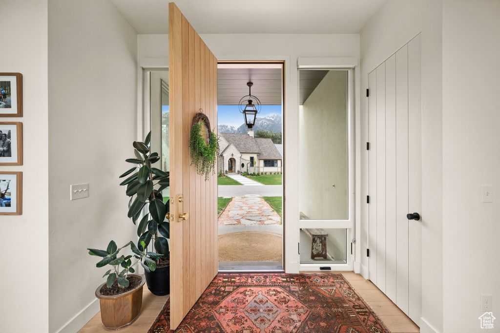 Foyer featuring baseboards and light wood-style floors