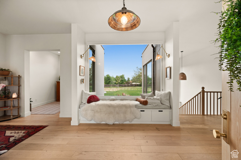 Foyer entrance with light wood-style floors and baseboards