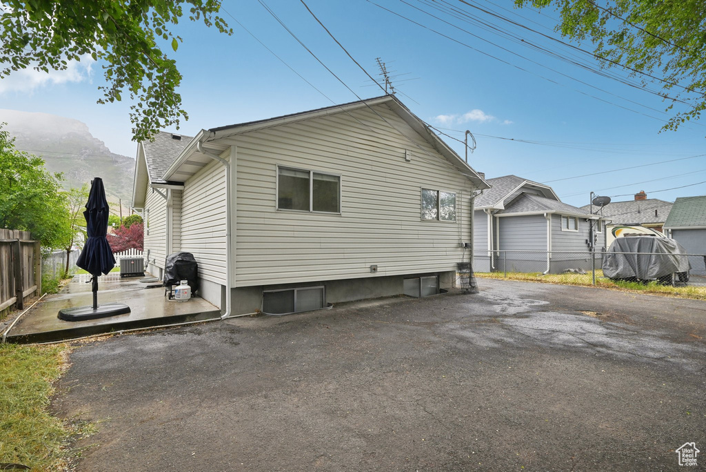 View of home\'s exterior featuring fence and central air condition unit