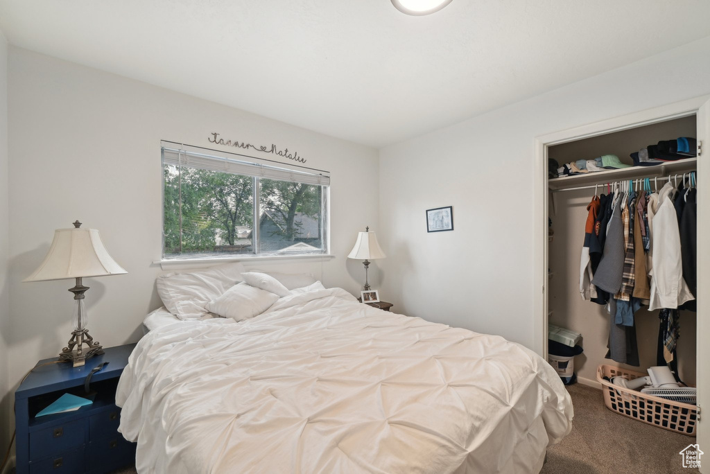 Carpeted bedroom with a closet