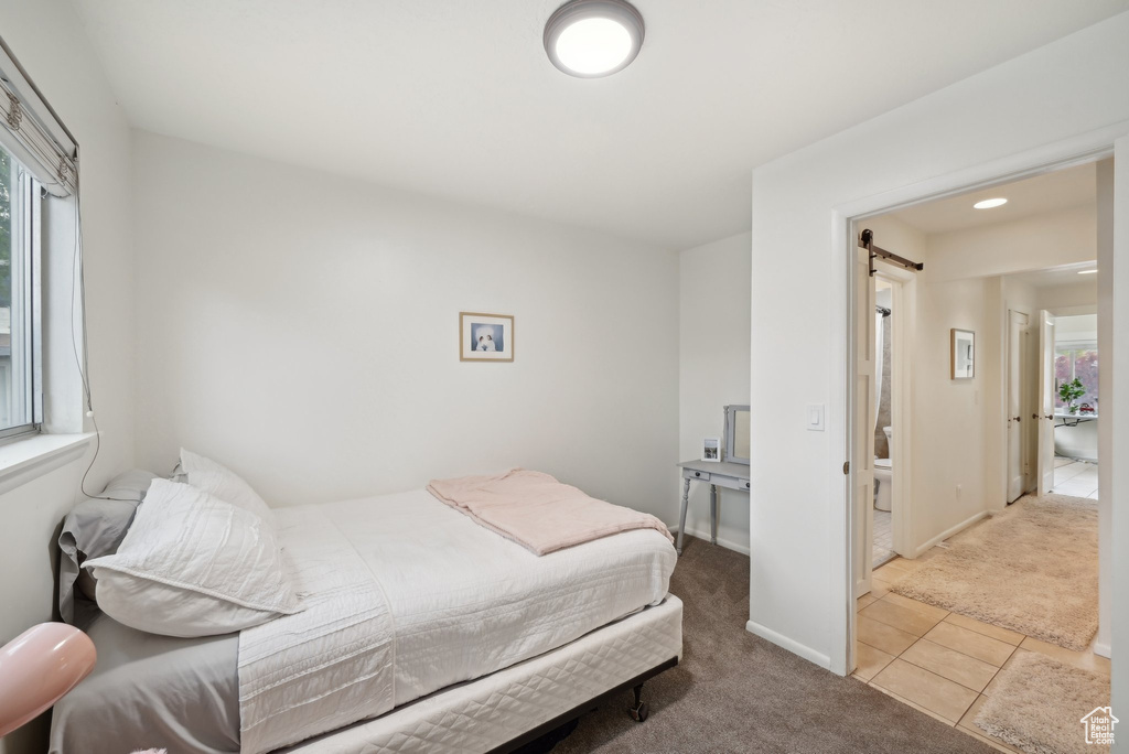 Bedroom with carpet floors, multiple windows, tile patterned floors, and recessed lighting