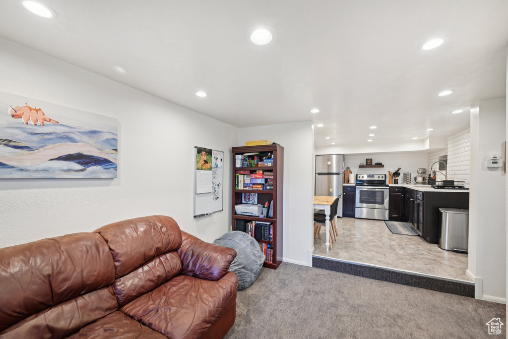 Living area featuring recessed lighting, light carpet, and baseboards