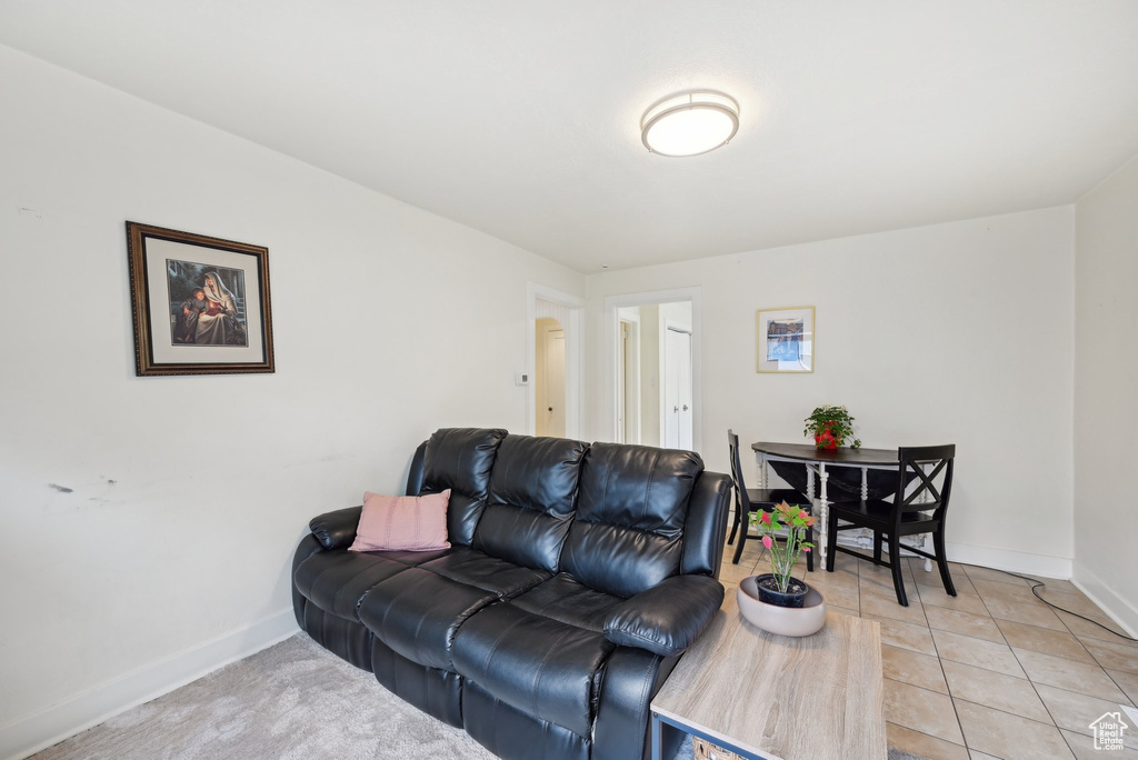 Living area with baseboards and light tile patterned floors