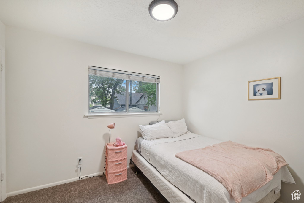 Carpeted bedroom with baseboards
