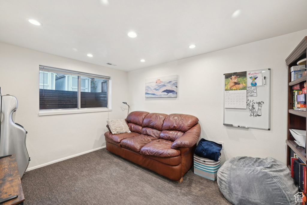 Carpeted living room with recessed lighting and baseboards