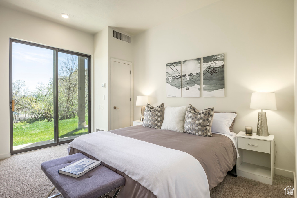 Carpeted bedroom featuring access to exterior and baseboards