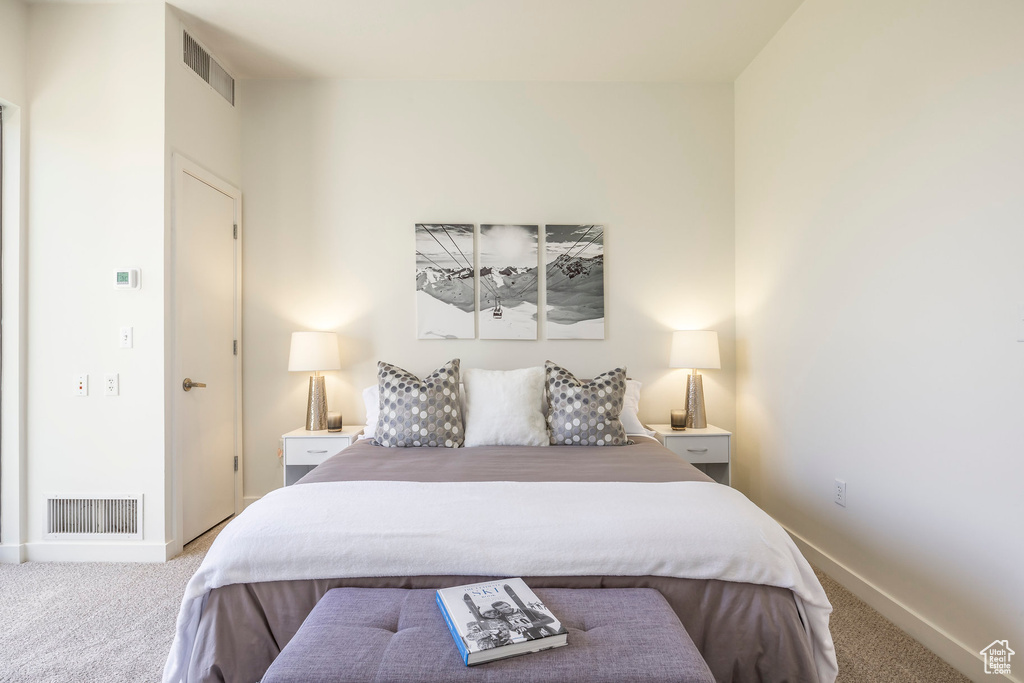 Carpeted bedroom with baseboards