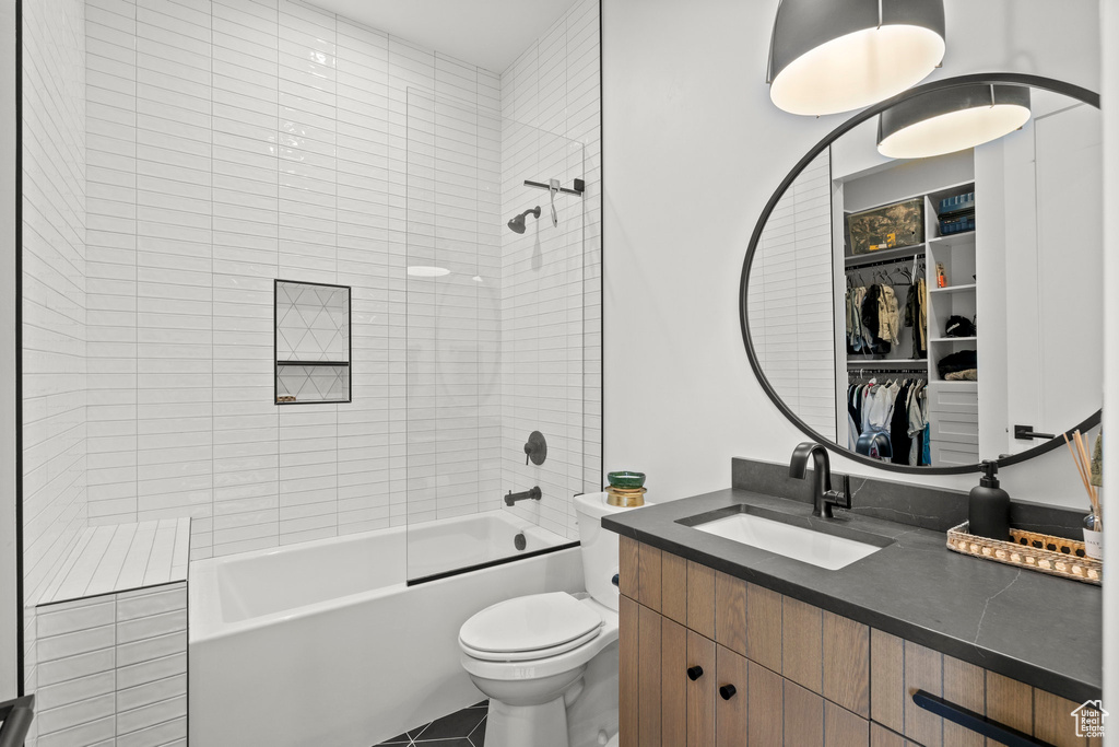 Bathroom with toilet, bathing tub / shower combination, and vanity