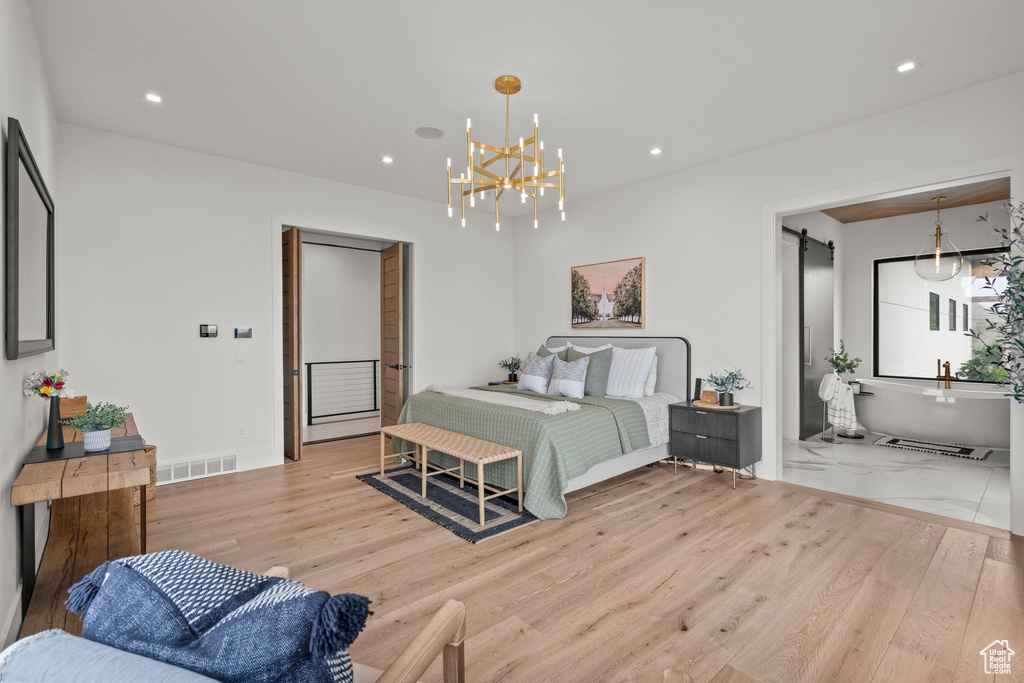 Bedroom with wood finished floors, recessed lighting, and a chandelier