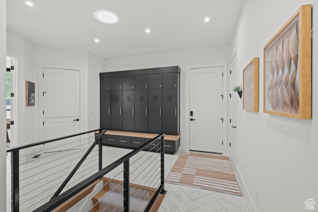 Foyer featuring marble finish floors, recessed lighting, and baseboards