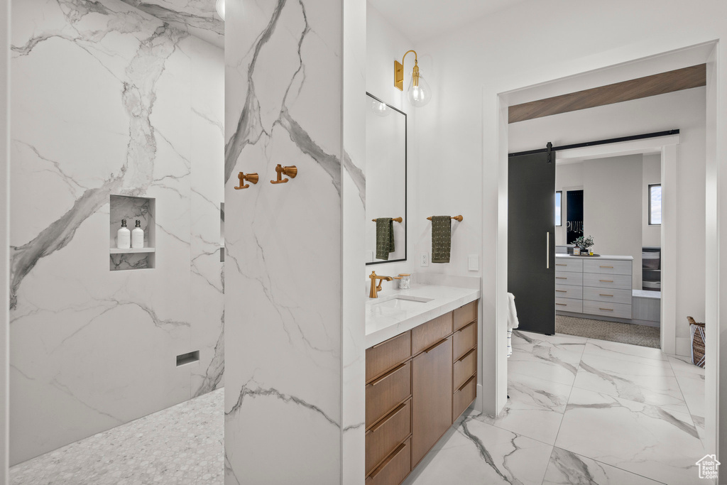 Bathroom featuring marble tiled flooring and vanity