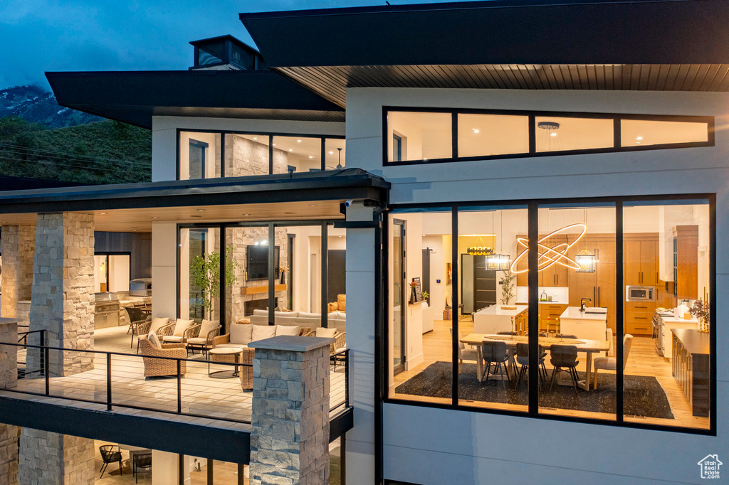 Rear view of house featuring outdoor lounge area