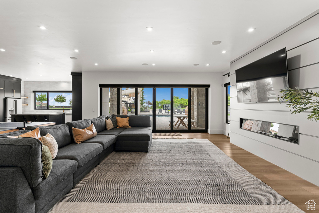 Living area featuring recessed lighting, light wood finished floors, and plenty of natural light