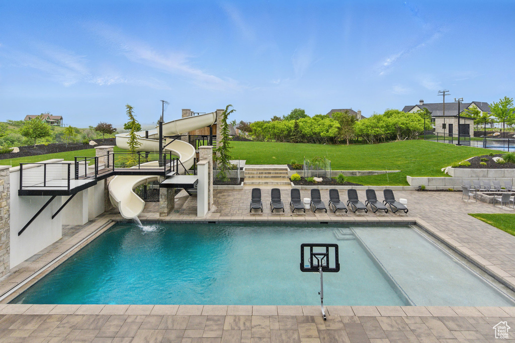 Outdoor pool featuring a patio area and a water slide