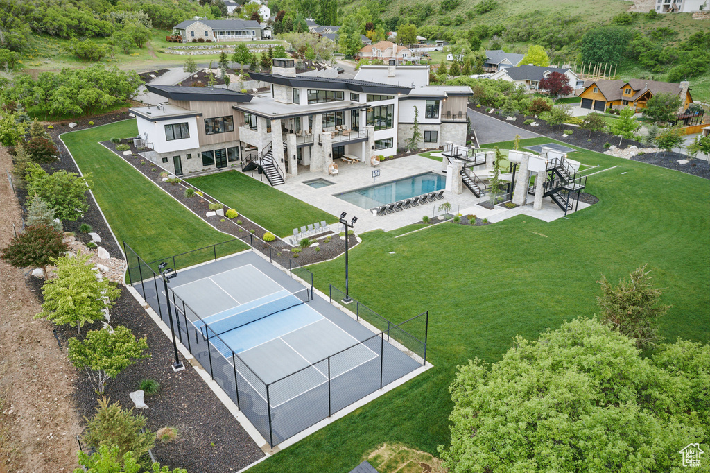 Aerial view of residential area featuring a pool area
