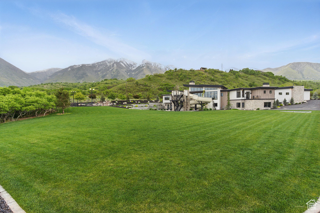 View of green lawn featuring a mountain view