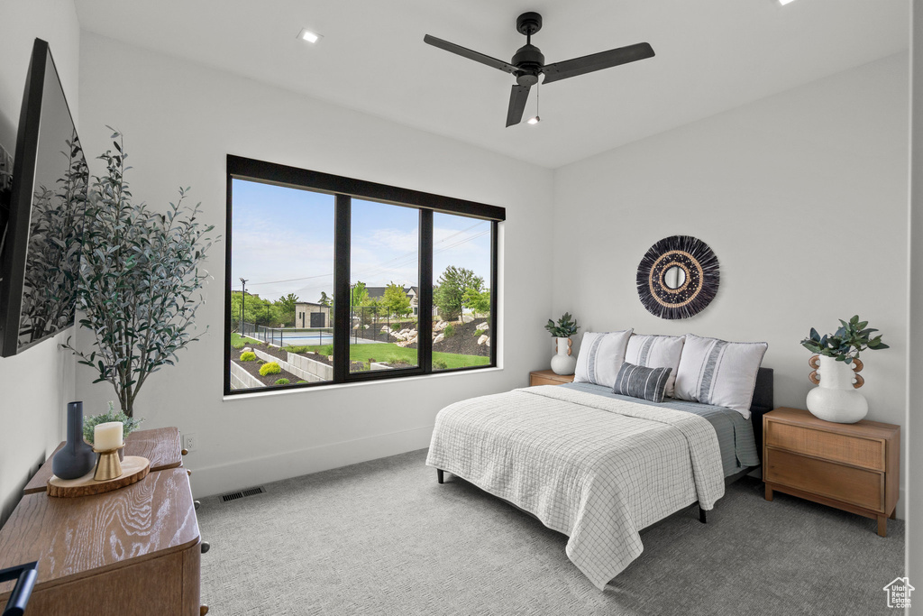 Bedroom with carpet floors, baseboards, and ceiling fan