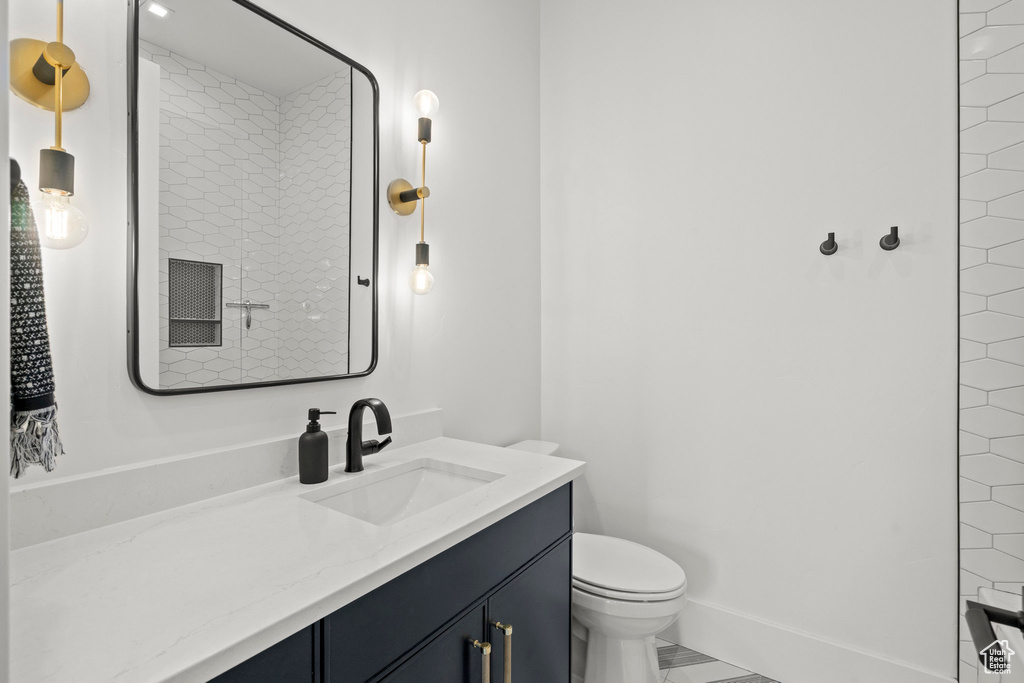 Full bath featuring toilet, vanity, and a shower