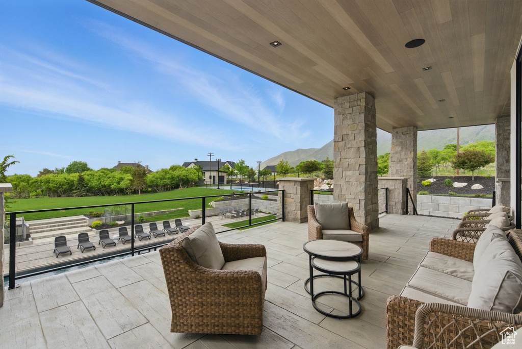 View of patio / terrace with an outdoor living space and a mountain view