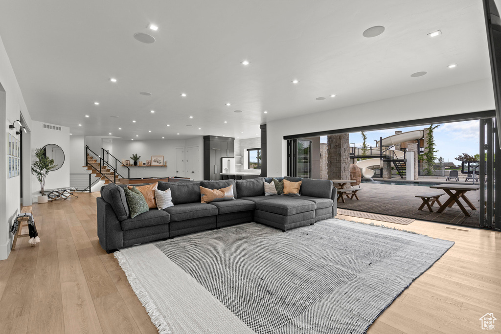 Living room featuring recessed lighting, stairway, and light wood finished floors