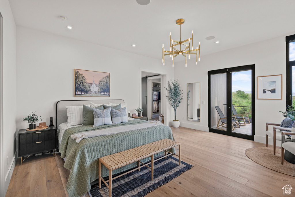 Bedroom featuring access to outside, light wood finished floors, a chandelier, recessed lighting, and baseboards