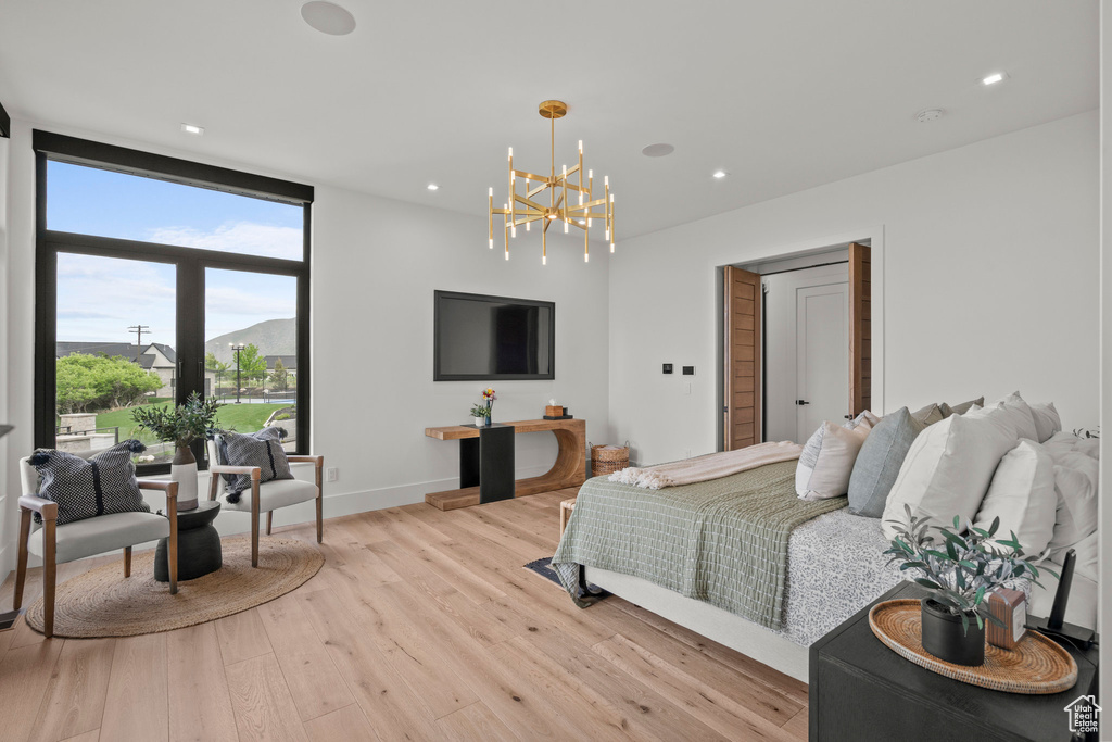 Bedroom with a chandelier, light wood-type flooring, recessed lighting, and baseboards