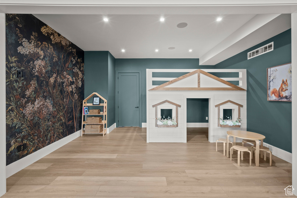 Playroom featuring wood finished floors, baseboards, and recessed lighting