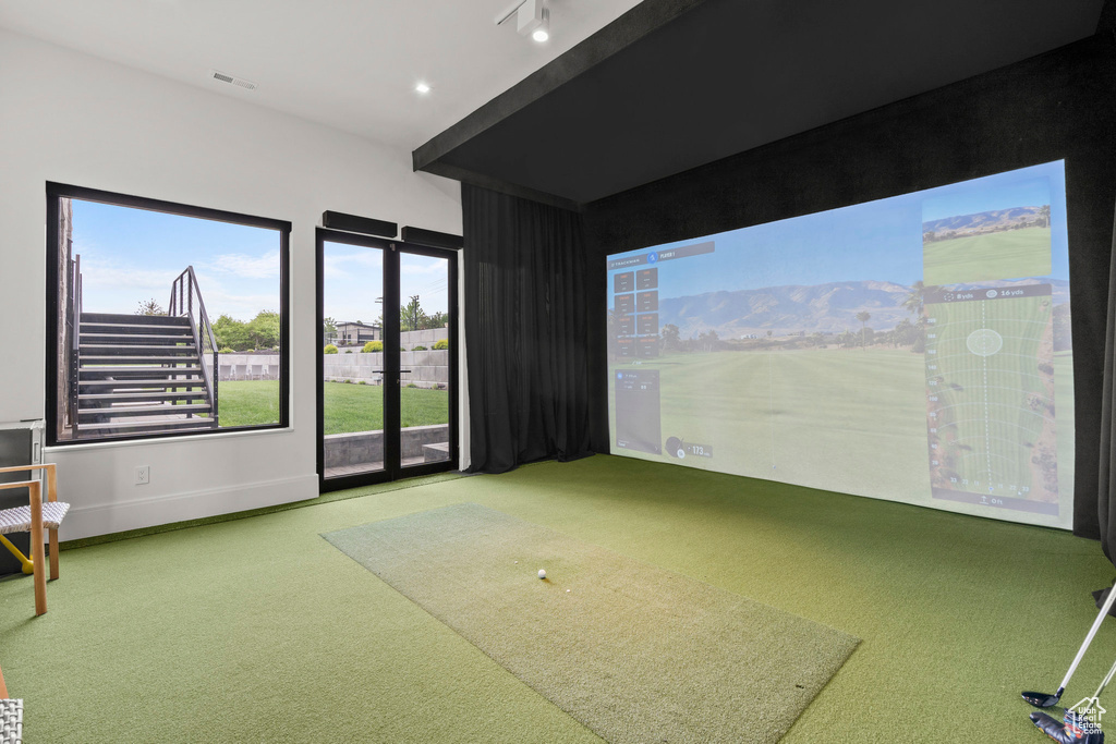 Game room featuring golf simulator, carpet, and baseboards