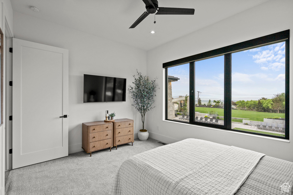 Bedroom featuring light carpet, recessed lighting, ceiling fan, and baseboards